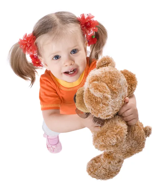 Meisje in oranje met speelgoed. — Stockfoto