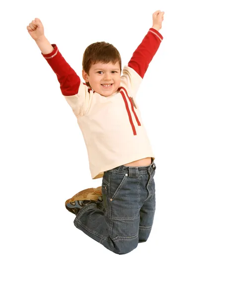 Divertido menino em jeans salto em altura . — Fotografia de Stock