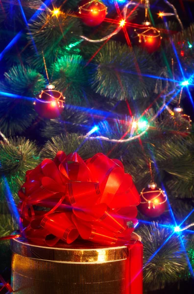 Kerstboom met flash en geschenk doos. — Stockfoto