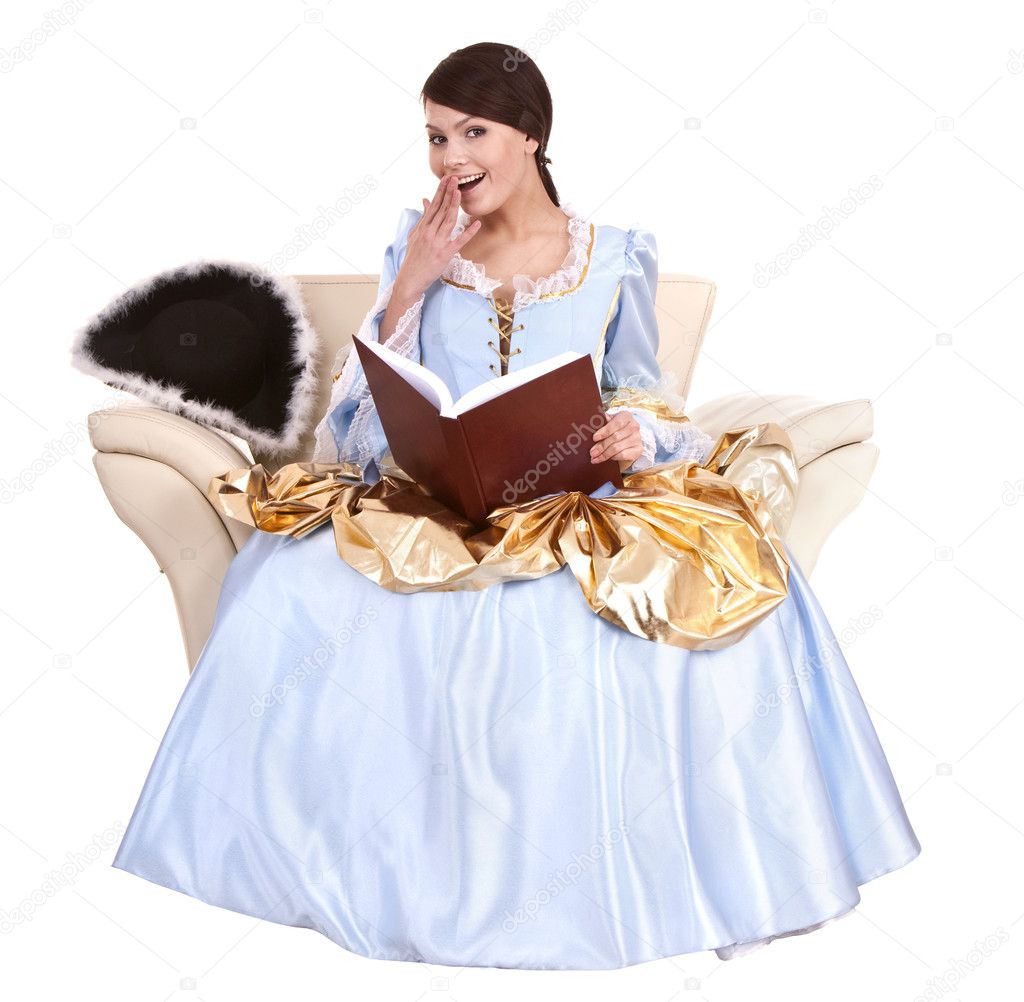 Girl in blue dress with book on chair.