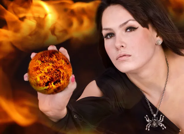 Witch with fire ball on flame. — Stock Photo, Image