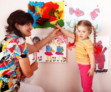 Child with teacher draw paints clipart