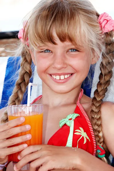 Child girl in red bikini drink juice. — Stock Photo, Image