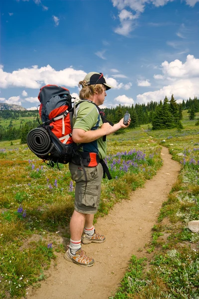 Hiker checking a GPS — Stock Photo, Image