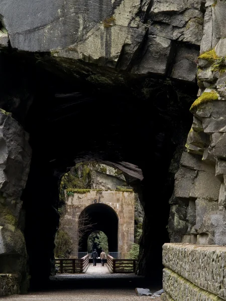Toeristen lopen door spoorweg tunnel — Stockfoto