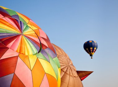 Hot air balloon in the air above two clipart