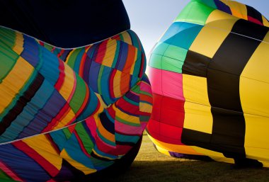 Two Hot air balloons being inflated clipart