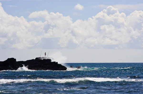 Silueta de un pescador sobre rocas —  Fotos de Stock