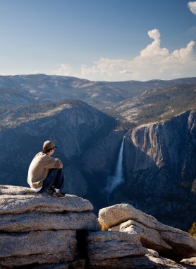 Young hiker overlooking Yosemite falls clipart