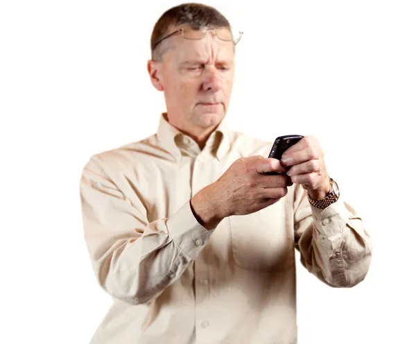 Middle aged man squinting at smart phone — Stock Photo, Image