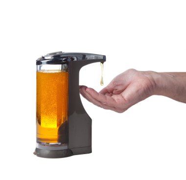 Soap being dispensed into hand clipart