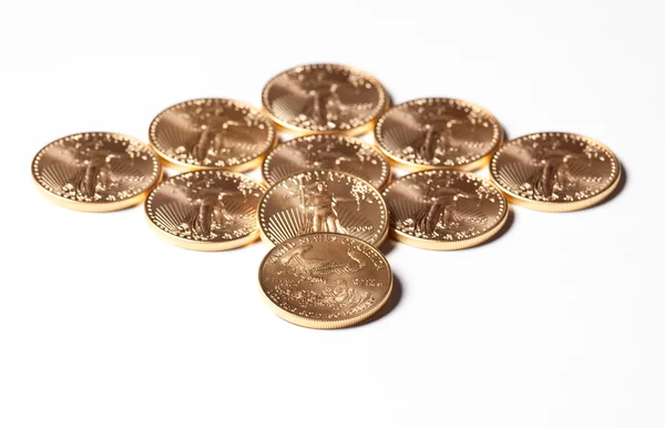 Diamond shaped gold coins on white — Stock Photo, Image