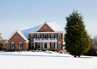 Modern single family home in snow clipart