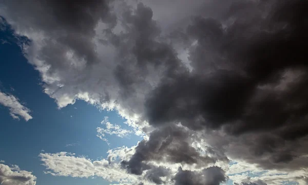 stock image The dark blue sky with cumulus clouds