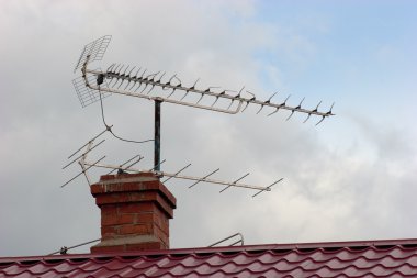 Antenna on a roof of the suburban house clipart