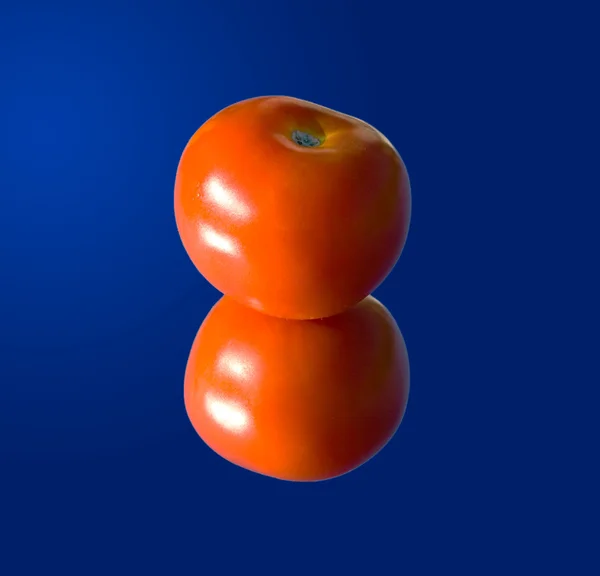 Tomato on a mirror — Stock Photo, Image