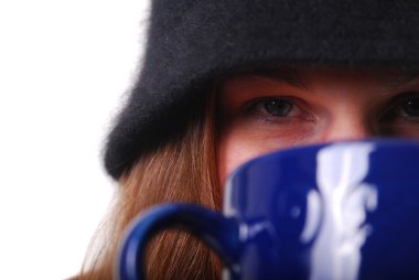 Woman keeping warm with cup of soup or c clipart