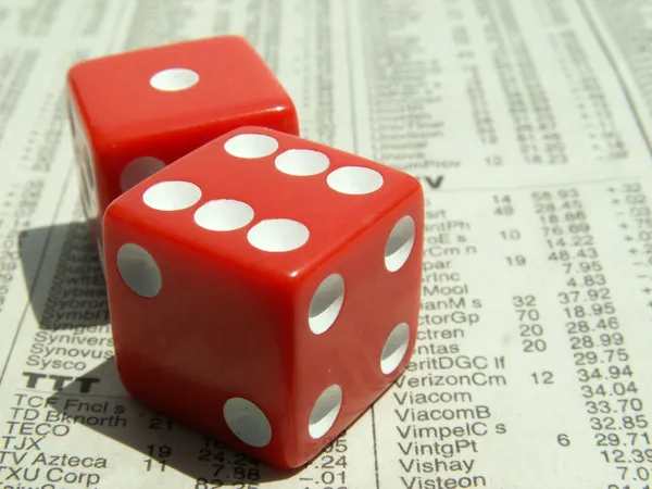 Red dice on stock report — Stock Photo, Image
