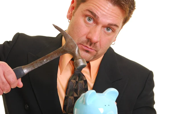 Homem de negócios com um martelo e porquinho proibição — Fotografia de Stock