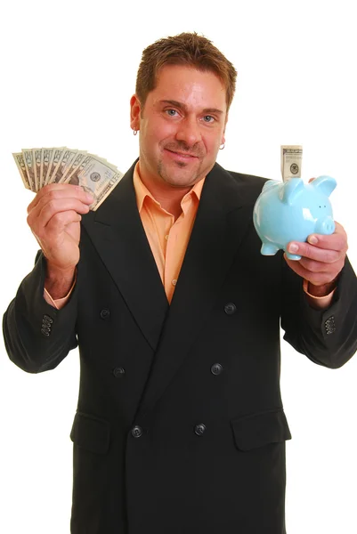 Obchodní muž držící peníze a pigg — Stock fotografie