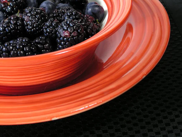 Berries and orange bowl — Stock Photo, Image