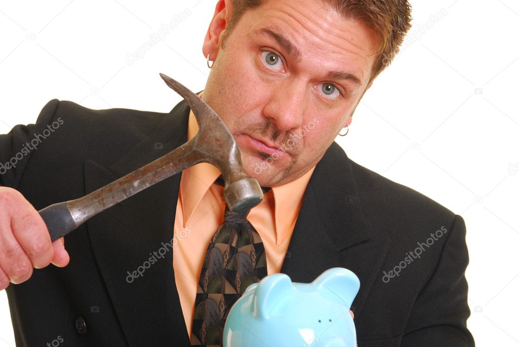 Business man with a hammer and piggy ban