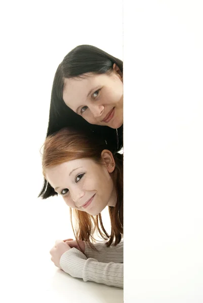 Smiling teen girls with blank sign — Stock Photo, Image