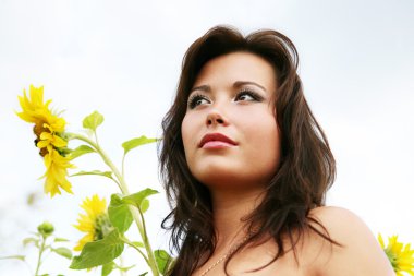 The young woman with sunflowers. clipart