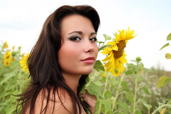 Woman with sunflowers — Stock Photo, Image