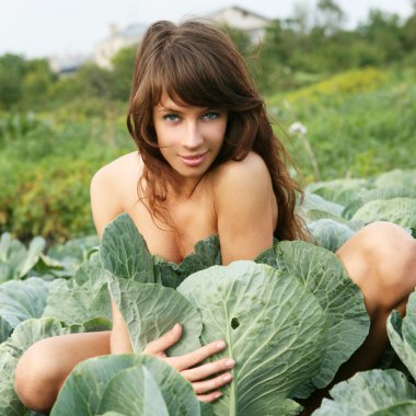 The young girl hides in cabbage. clipart