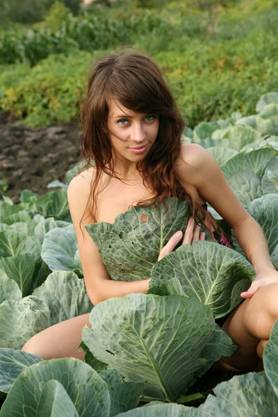Mujer joven en planta de col — Foto de Stock