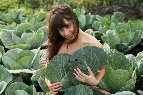 Young woman in plant of cabbage — Stock Photo, Image