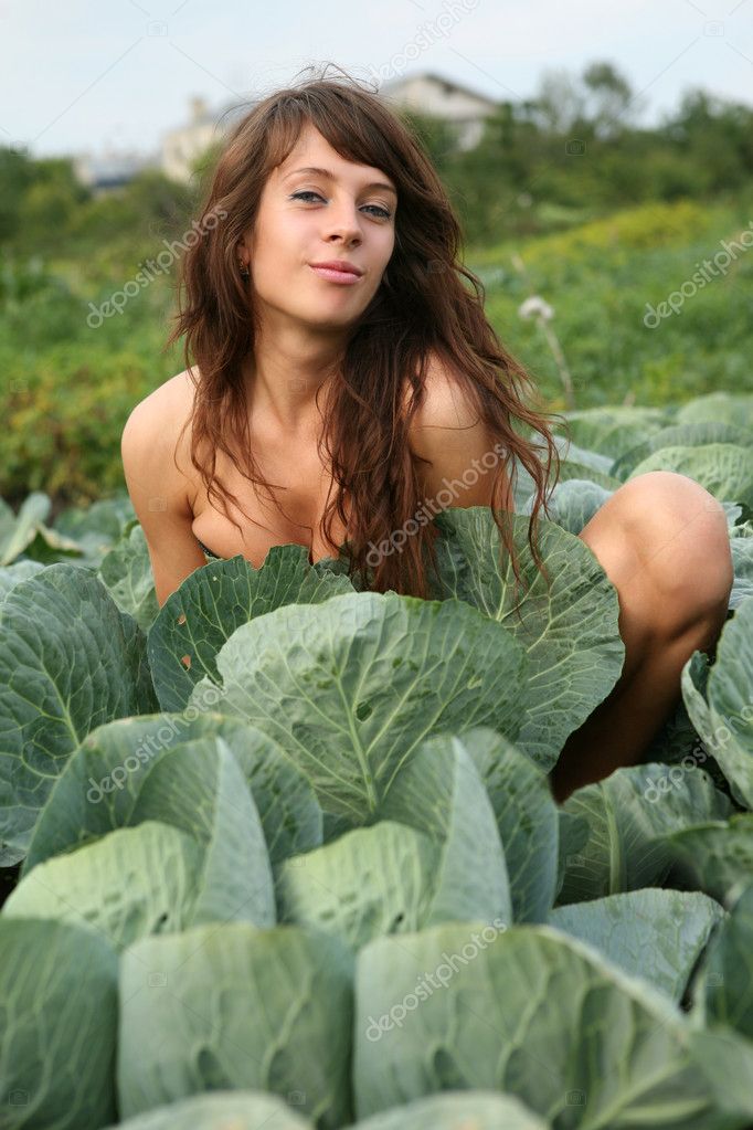 The young girl hides in cabbage Stock Photo by ©Artgo-biz1217478