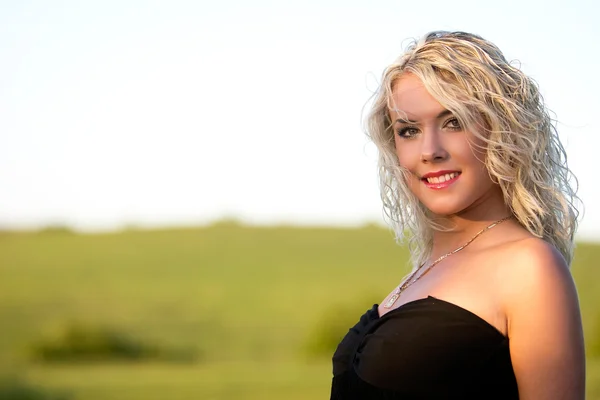 Stock image The young woman in a black dress.