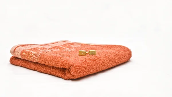 Orange towel and cuff links — Stock Photo, Image