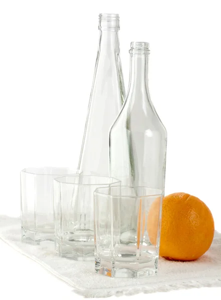 stock image Empty bottles glasses and orange