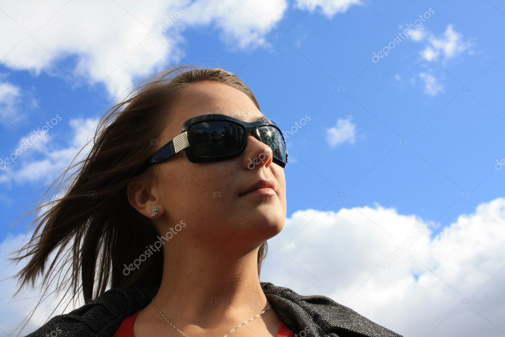 The nice girl against the blue sky