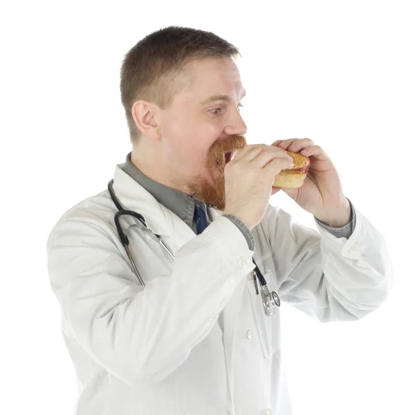 Doctor eats hamburger — Stock Photo, Image