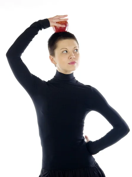 Girl holds apple on her head — Stock Photo, Image