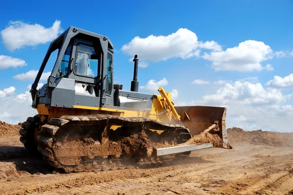 Bulldozer with raised blade in action — Stock Photo, Image