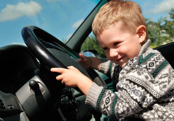Smiling boy and steering wheel — Stock Photo, Image