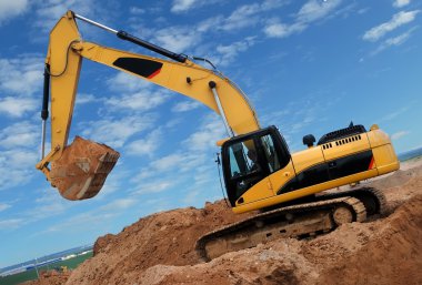 Excavator in sandpit clipart