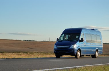 Blue minibus on highway clipart