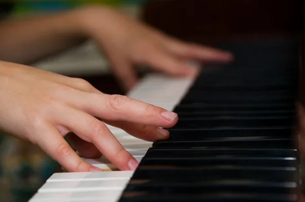 Händer på tangenterna på ett piano — Stockfoto