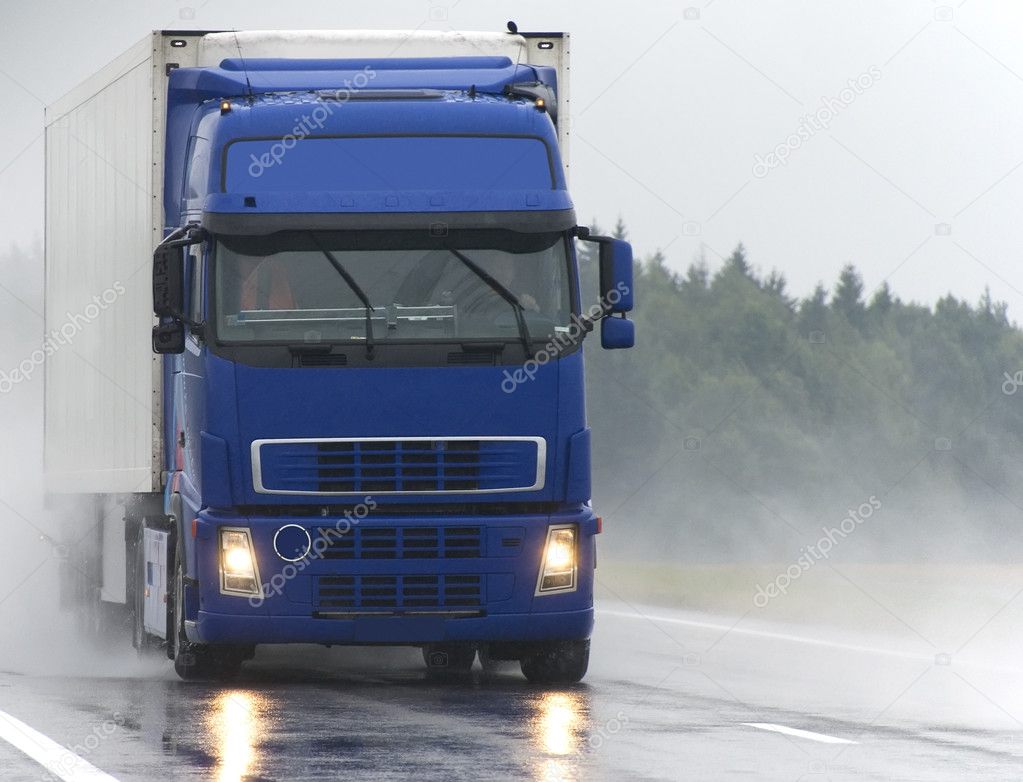 Blue Lorry on wet road