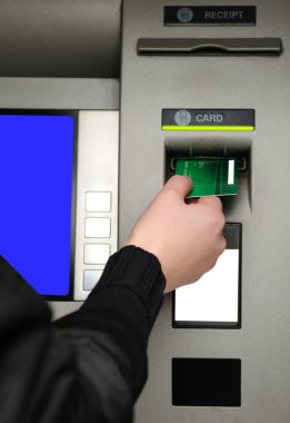 Inserting plastic card visa into ATM clipart