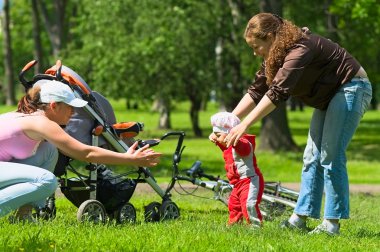 Mother and babysitter learn to walk baby clipart