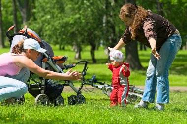 Mother and babysitter learn child to do clipart