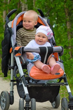 Two babies in children buggy clipart