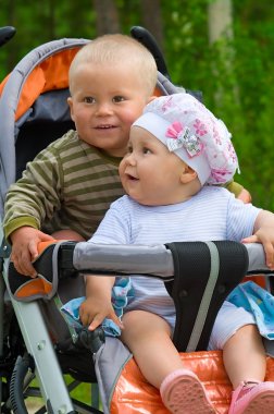 Two babies in children stroller clipart